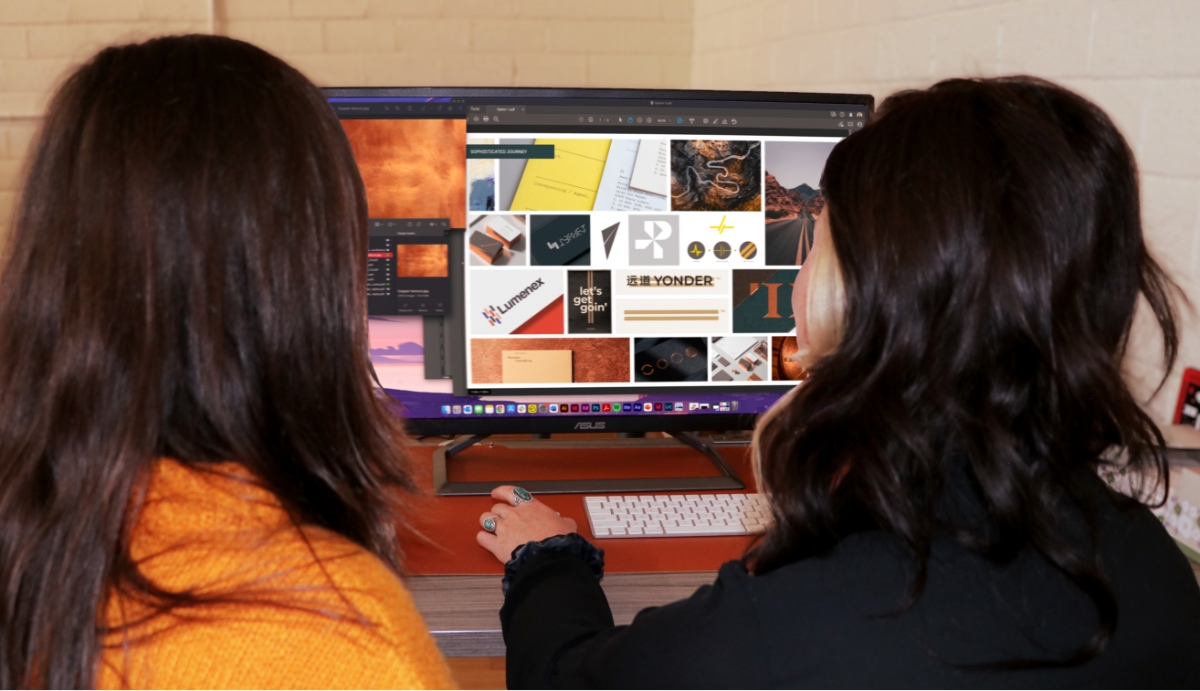 Photo of two people looking at content on a monitor