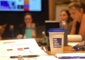 Photo of Connective Agency meeting with coffee cup in foreground